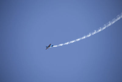 Low angle view of airplane flying in sky