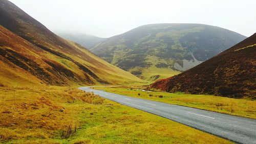 Country road leading towards mountains