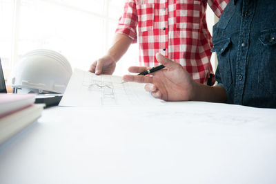 Midsection of man working on table