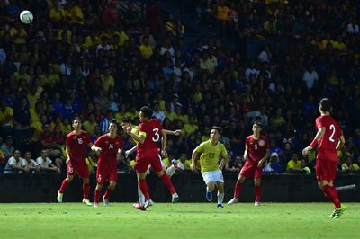 Group of people playing soccer on field