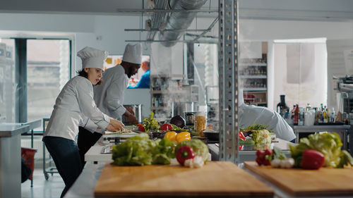 Chefs preparing food in kitchen