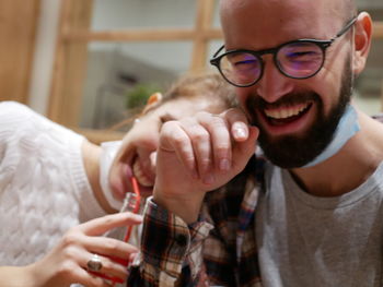 Portrait of smiling young man holding eyeglasses