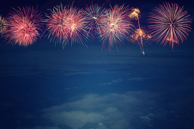 Low angle view of firework display at night