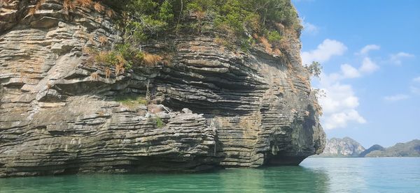 Rock formation in sea against sky