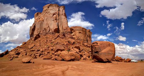 Rock formations against cloudy sky