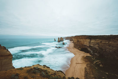 Scenic view of sea and rock formations against sky