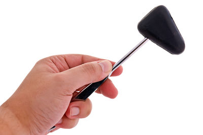 Close-up of hand holding eyeglasses against white background