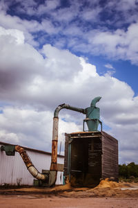 Low angle view of machinery against sky