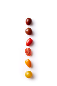 Close-up of tomatoes over white background