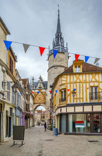 Street amidst buildings in city against sky