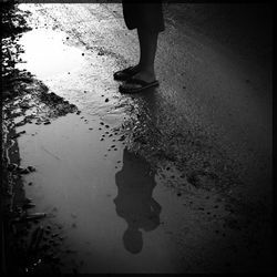 Low section of people standing in puddle