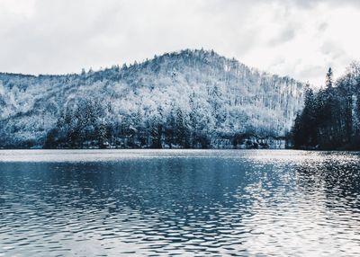 Scenic view of lake against sky during winter