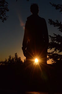 Low angle view of silhouette man against sky during sunset