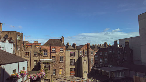 Buildings in town against blue sky