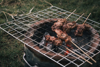 High angle view of meat on barbecue grill