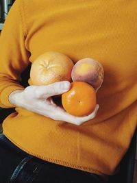 High angle view of hand holding fruit