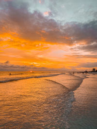 Scenic view of sea against orange sky