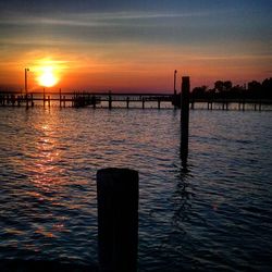 Pier on sea at sunset