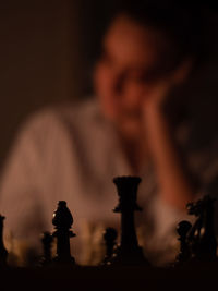 Close-up of man playing on chess board