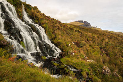 Scenic view of waterfall against sky