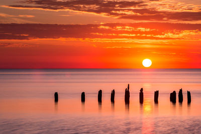 Scenic view of sea against orange sky