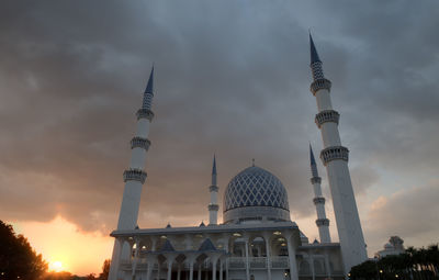 Low angle view of building against cloudy sky