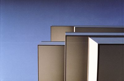 Low angle view of building against clear blue sky