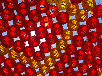 Low angle view of lanterns hanging on red wall