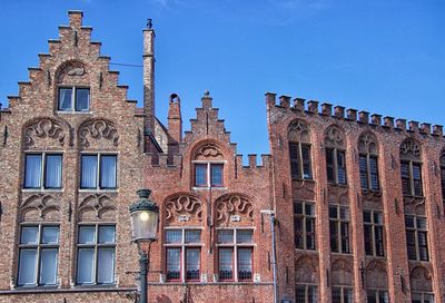 Low angle view of historical building against blue sky