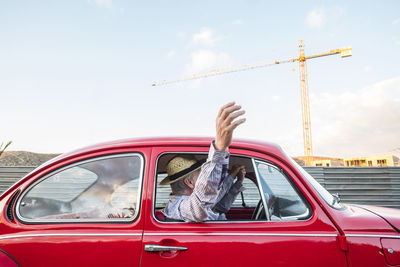 Cheerful senior couple traveling in car