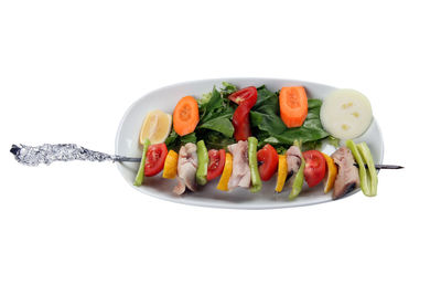 Fruits in plate against white background