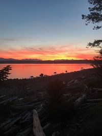 Scenic view of sea against romantic sky at sunset