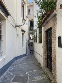 Footpath amidst buildings in city