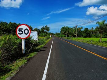 Road sign against sky