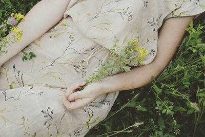 Midsection of woman lying on field