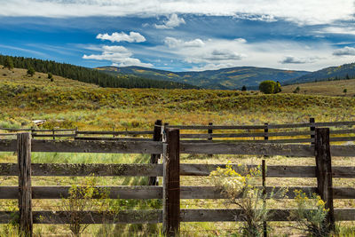 Fence on landscape against sky