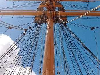 Low angle view of sailboat against blue sky