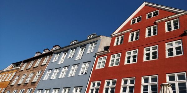 Low angle view of buildings against blue sky