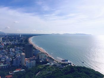 High angle view of buildings by sea against sky