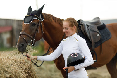 Side view of horse standing on field