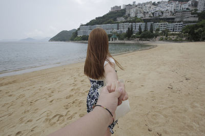 Woman on beach against sky