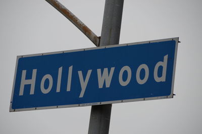 Low angle view of road sign against clear sky