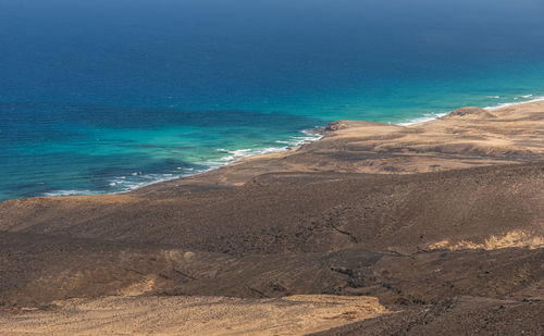 Scenic view of beach against blue sky