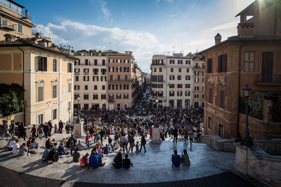 People on street amidst buildings in city