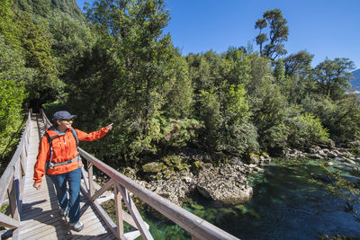 Woman crossing wooden bridge at caleta gonzalo in chile