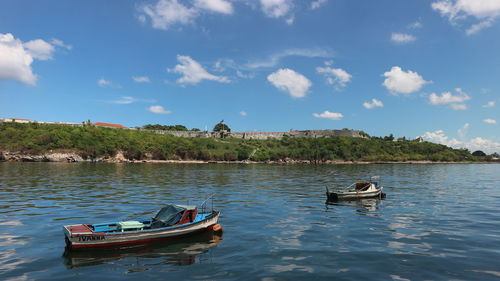 Boat moored in river against sky