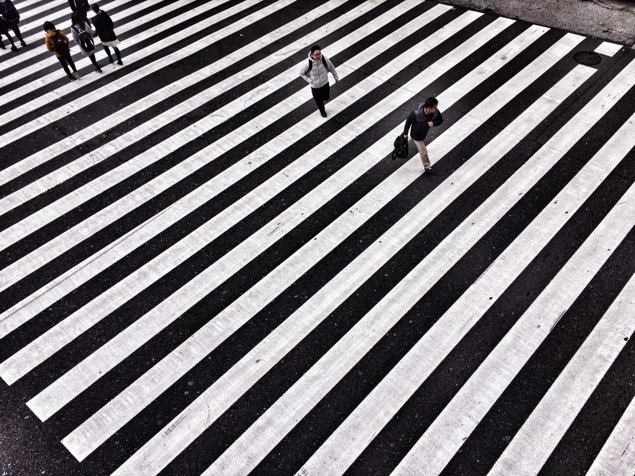 HIGH ANGLE VIEW OF WOMAN WALKING ON TILED FLOOR