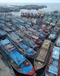 High angle view of fishing boats moored at harbor