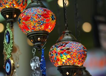 Close-up of illuminated lanterns hanging at market