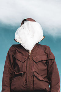 Rear view of person standing on snow against sky